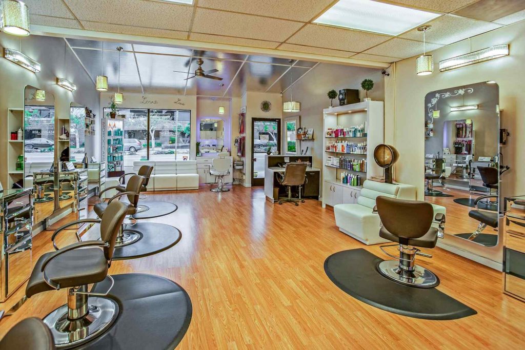 A modern hair salon with chairs, mirrors, and beauty products