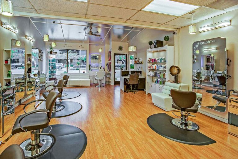 A modern hair salon with chairs, mirrors, and beauty products